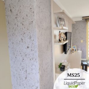 Sala de estar com televisão porem com evidêcia um canto de parede com o Papel de Parede Líquido Linha Marmore no modelo ms25 de fundo claro com pontos em marrom etilo marmore